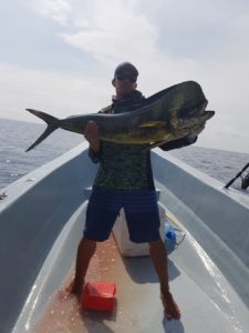 sport fishing guy holding a dorado