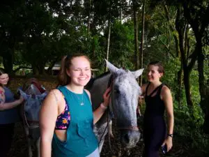 Horses and girls posing for a photo