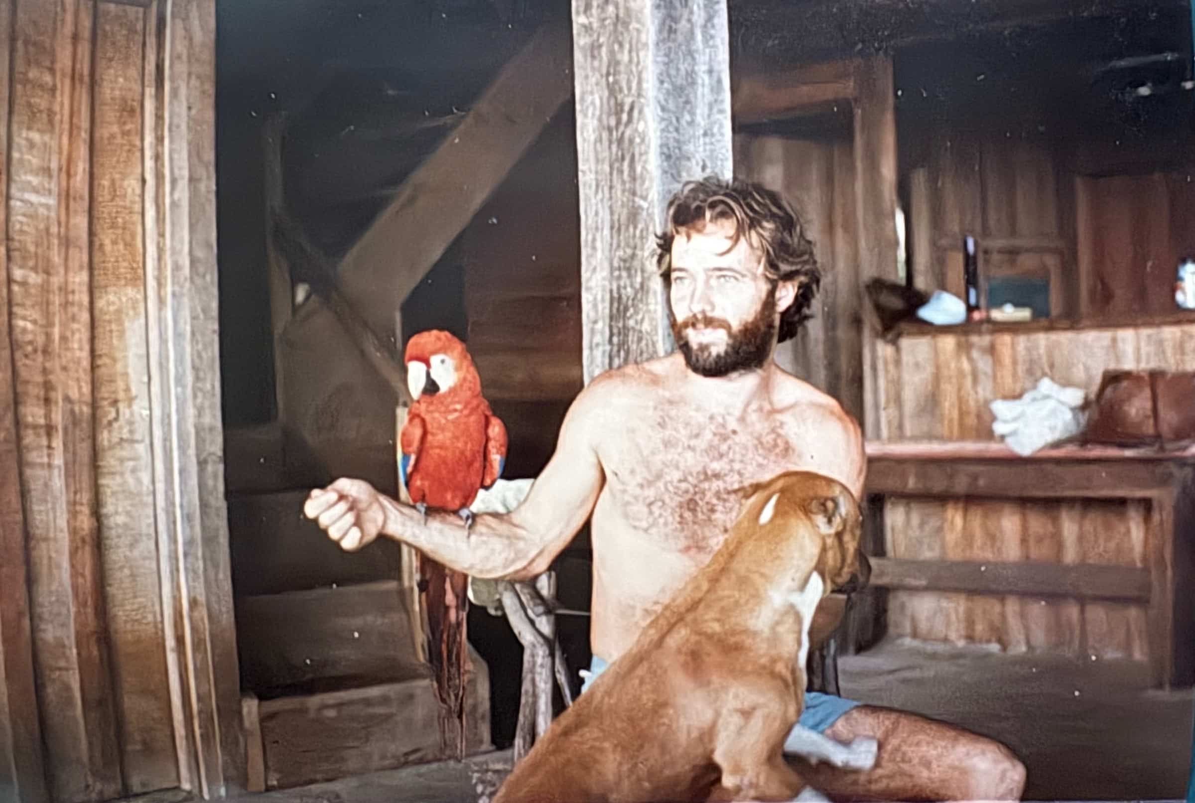 Peter Aspinall with Azura, the family’s scarlet macaw, and their dog Fuji at Tiskita in the mid-1980s